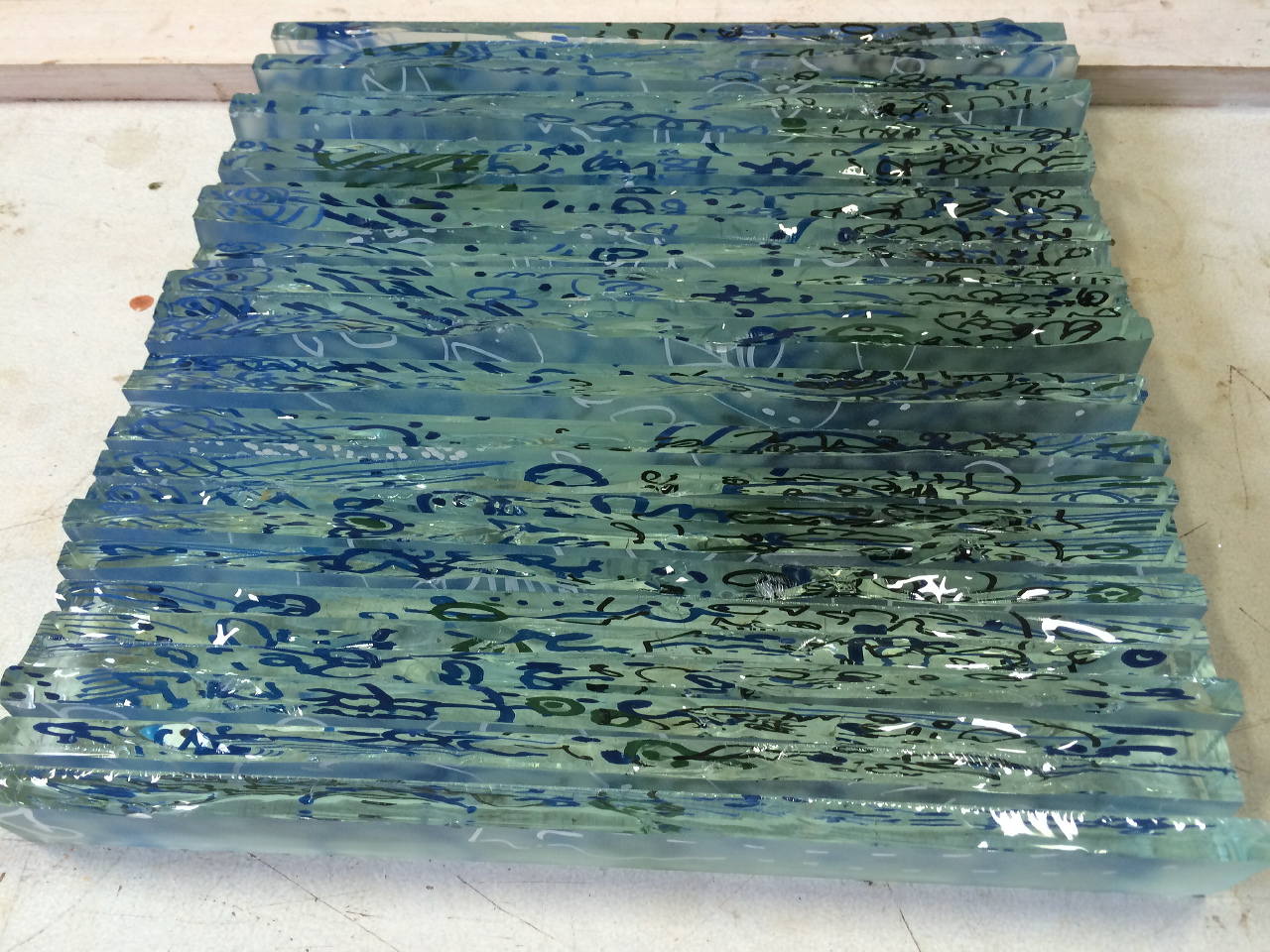 Fused glass strips in abstract composition