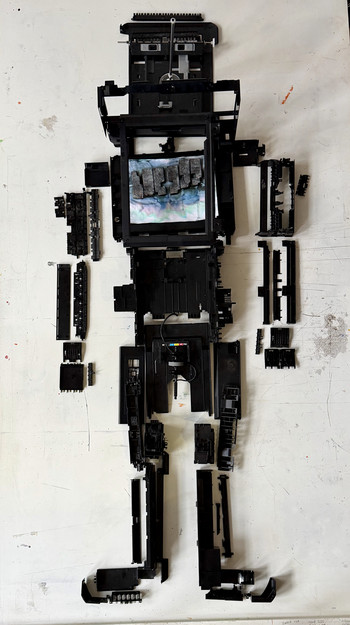 Full figure self-portrait composed of inkjet printer components